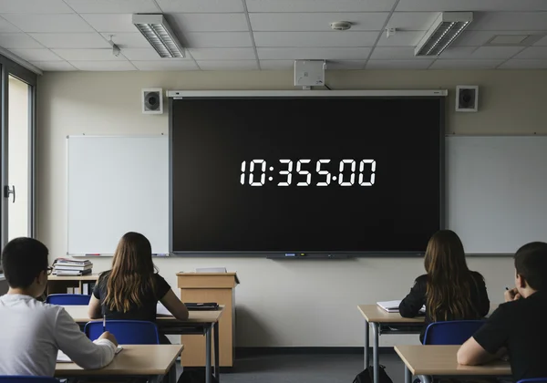 Large digital clock projected in a modern classroom setting
